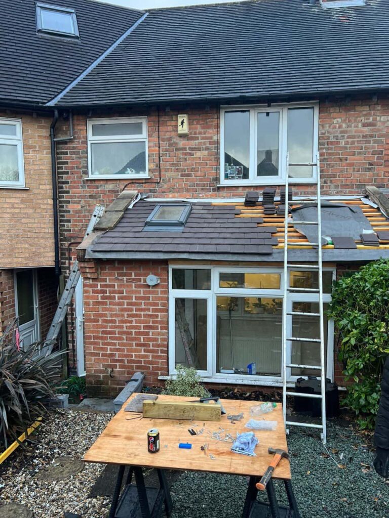 This is a photo of a roof extension that is having new roof tiles installed. This is a photo taken from the roof ridge looking down a tiled pitched roof on to a flat roof. Works carried out by Shirebrook Roofing Repairs