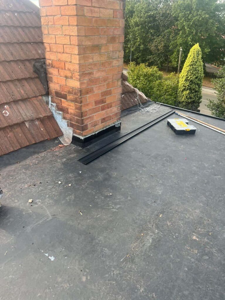 This is a photo of a flat roof which has just been repaired, there is also a chimney stack and some leadwork has also been dressed. Works carried out by Shirebrook Roofing Repairs